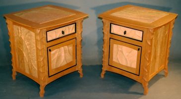 A pair of carved Cherry and Birdseye Maple bedside cabinets
